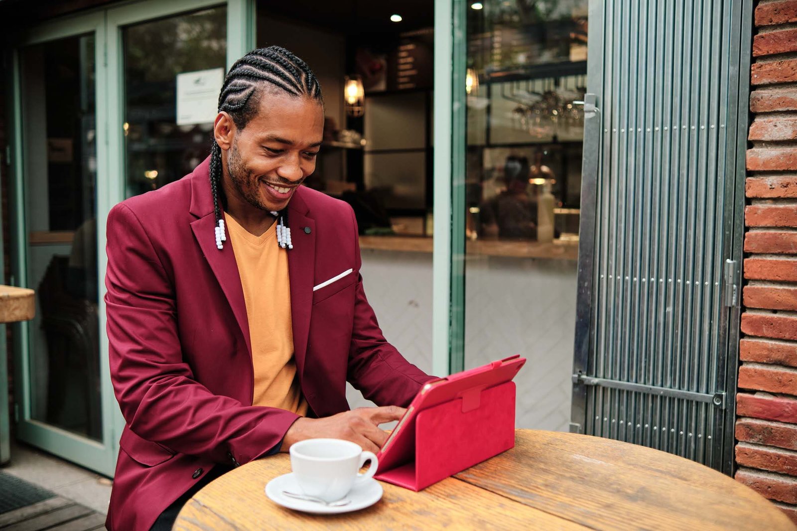 African man using a tablet in a cafeteria